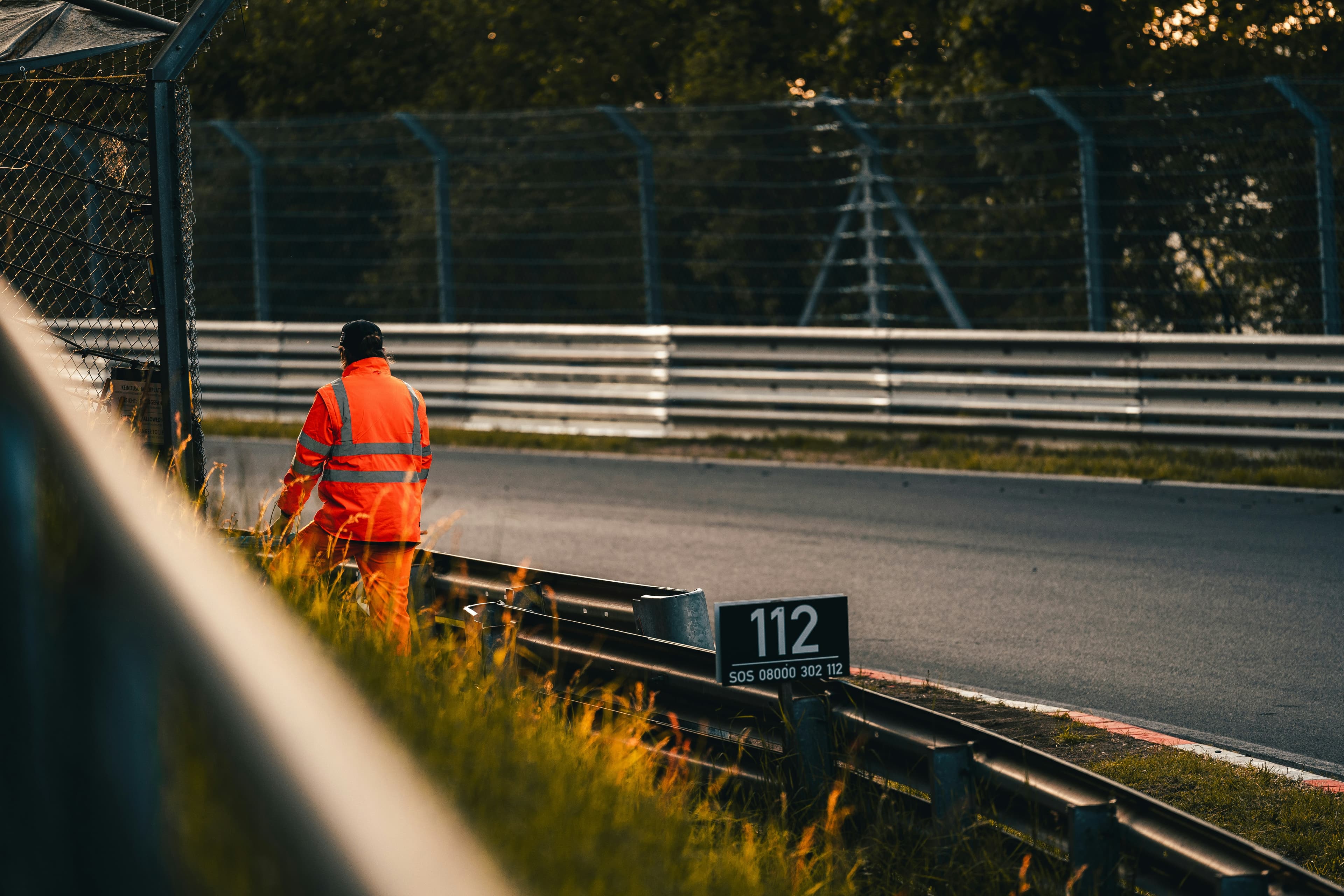 Runners at a road race event with race marshals and event volunteers